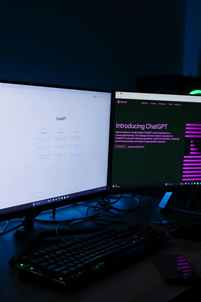 blog Vertical shot of a dual monitor setup with ChatGPT on screens, ideal for technology and AI concepts.